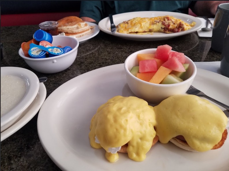 Eggs Benedict with fresh fruit, omelet and pancakes at Amy's Cafe
